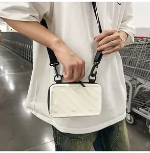 Detail view of white hardshell suitcase mini bag with vertical stripes and black strap