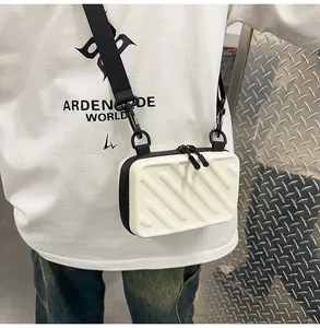 Detail of white hardshell crossbody bag with striped texture and black shoulder strap
