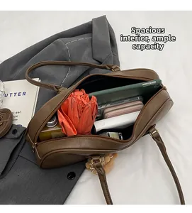 Detailed interior of brown leather shoulder bag showing spacious capacity for daily essentials
