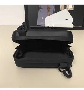 Top view of open black rectangular crossbody bag showing spacious interior and zipper