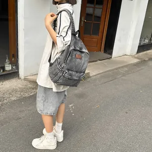 Sac à dos unisexe en denim gris délavé avec logo en cuir pour l'école ou usage quotidien