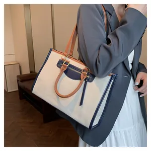 Detail of the large canvas tote bag showing retro contrast colors and leather textures