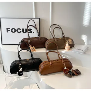 Detail view of baguette bags in four colors with plush charms and extra straps