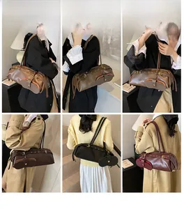 Chic burgundy motorcycle-style baguette bag with long shoulder strap and buckle details