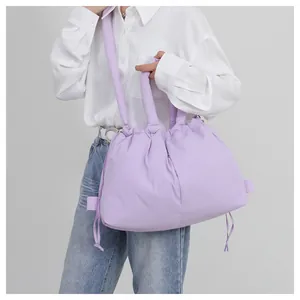 Detail of lavender puffer tote bag featuring soft quilted texture and drawstring closure