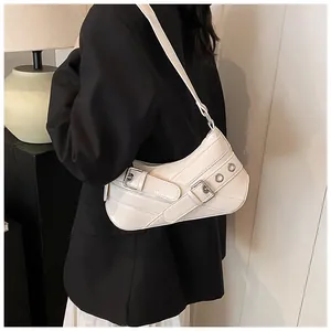Detailed side view of a stylish cream shoulder bag with metallic buckle and leather texture