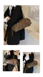Detail showing vintage brown long baguette bag with decorative buckles and eyelets