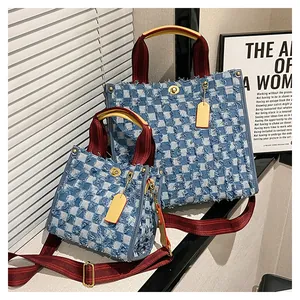 Close-up of checkerboard denim tote bags with yellow leather handles and stripe straps
