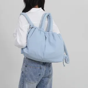 Light blue puffer backpack with quilted texture shown on a model for casual daily use