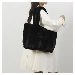 Close-up of black faux fur tote bag with wide handle showing soft silky texture and large capacity