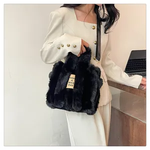 Detail of black plush tote bag with Have a Nice Day tag and metal buckle accents