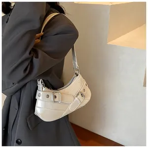 Detail of cream white half-moon underarm bag with silver buckles on grey suit model