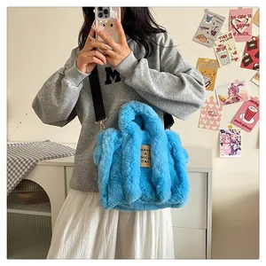 Detail of blue faux fur tote bag showing plush texture and Have a Nice Day patch