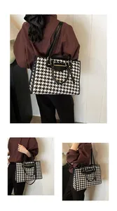 Detail of large houndstooth tote bag with black leather trim and adjustable strap