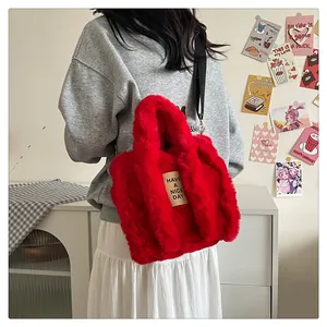 Detail of red plush tote bag showing soft faux fur texture and 'HAVE A NICE DAY' label