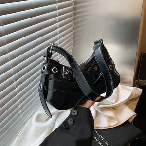 Chic black patent leather underarm bag with silver eyelet studs and buckle details