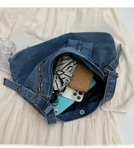 Top view of spacious denim tote bag interior holding a wallet, umbrella and phone