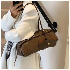Macro detail of deep brown leather shoulder bag with vintage buckles and buckle strap