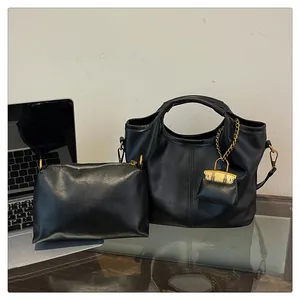 Three-piece black leather bucket bag set featuring a tote and pouch with gold hardware