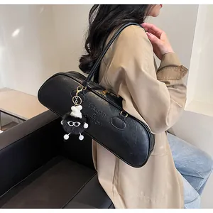 Close-up of black litchi texture baguette bag with MAJOR & SORDOW embossed text