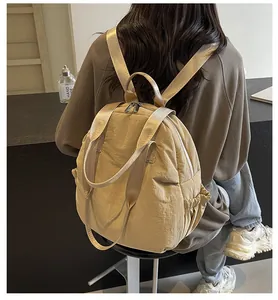 Detail of beige travel backpack featuring wrinkled texture and elastic side pocket