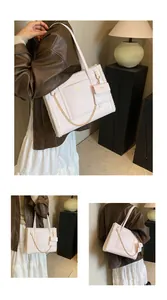 Detail of pink faux leather tote bag with white plush trim and golden chain strap accessory