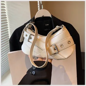 Detailed view of white PU underarm bag featuring silver double belt buckles and metal eyelets