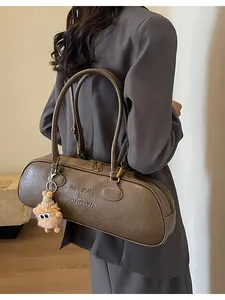 Retro taupe baguette shoulder bag with leather texture and plush monster charm pendant