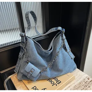 Blue denim hobo tote featuring silver chain detail and small matching coin purse