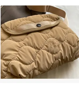 Detailed view of wave quilted nylon fabric texture and round black button closure