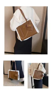 Detail showing plush fur trim on a brown tote bag with metal chain and mini pouch