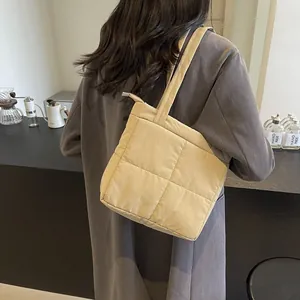 Minimalist beige quilted puffer tote bag with stitched grid pattern for casual daily wear