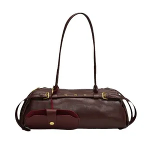 Deep burgundy leather baguette bag with metal buckle straps and mini pouch attachment