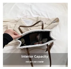 Macro shot showing internal capacity of the white fleece tote bag with brown leather handles