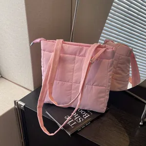 Pink quilted shoulder bag with soft nylon fabric and wide straps for casual daily commute