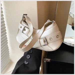 Detail view of cream motor-style hobo bag with silver buckles and Y2K aesthetic hardware