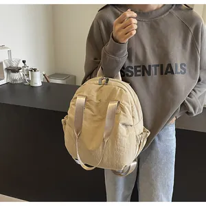 Detail of travel backpack showing reinforced straps and side drawstring pockets