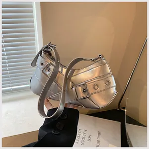 Detailed view of silver Y2K underarm bag with metallic buckle and eyelet decorations