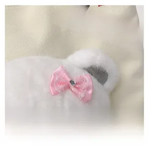 Close-up of cute white plush bear with pink lace bow on large canvas tote bag