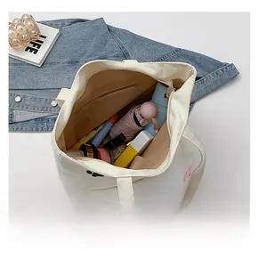 Detailed interior of canvas tote bag showing large capacity for umbrella and cosmetics