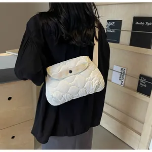 Detailed view of the off-white quilted crossbody bag with stylish wavy stitching detail