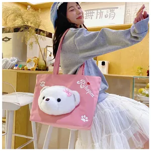 Pink canvas tote bag featuring a 3D plush bear head decoration shown on a shoulder