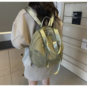 Olive green nylon travel backpack showing wide shoulder straps and side pocket for water bottle