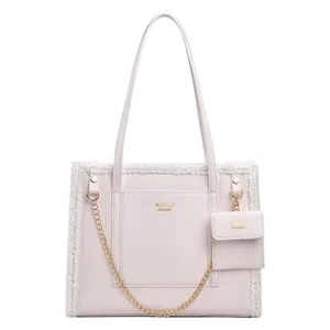 Chic cream faux leather tote bag with white plush trim and golden chain detail