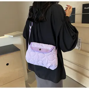 Close-up of quilted lavender crossbody bag showing fabric texture and snap closure