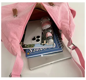Top view of pink corduroy dumpling bag showing large capacity with daily essentials