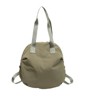 Minimalist khaki large capacity travel tote bag with rounded silhouette and drawstrings