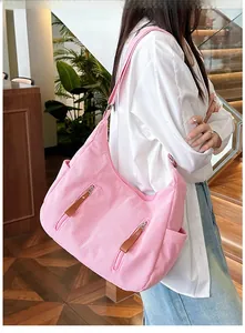 Pink corduroy hobo bag showing detailed texture, vertical zip pockets and wide strap