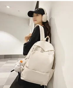 Minimalist large capacity waterproof cream backpack with plush duck charm side view