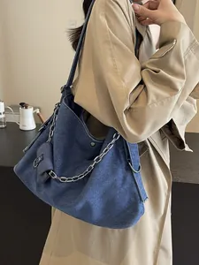 Large capacity dark blue denim tote bag with chain strap and mini pouch on model